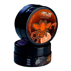 Cera Cremosa Authentic Vision Imperial con diseño naranja y negro, apilados para mostrar la tapa y el lateral.